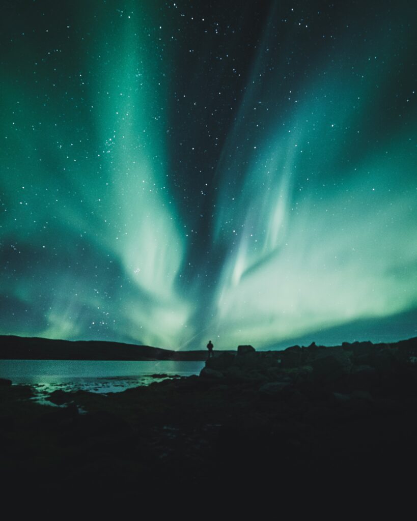 A scenic view of Iceland featuring the country's picturesque landscapes with solar panels installed, showcasing Iceland's commitment to renewable energy.