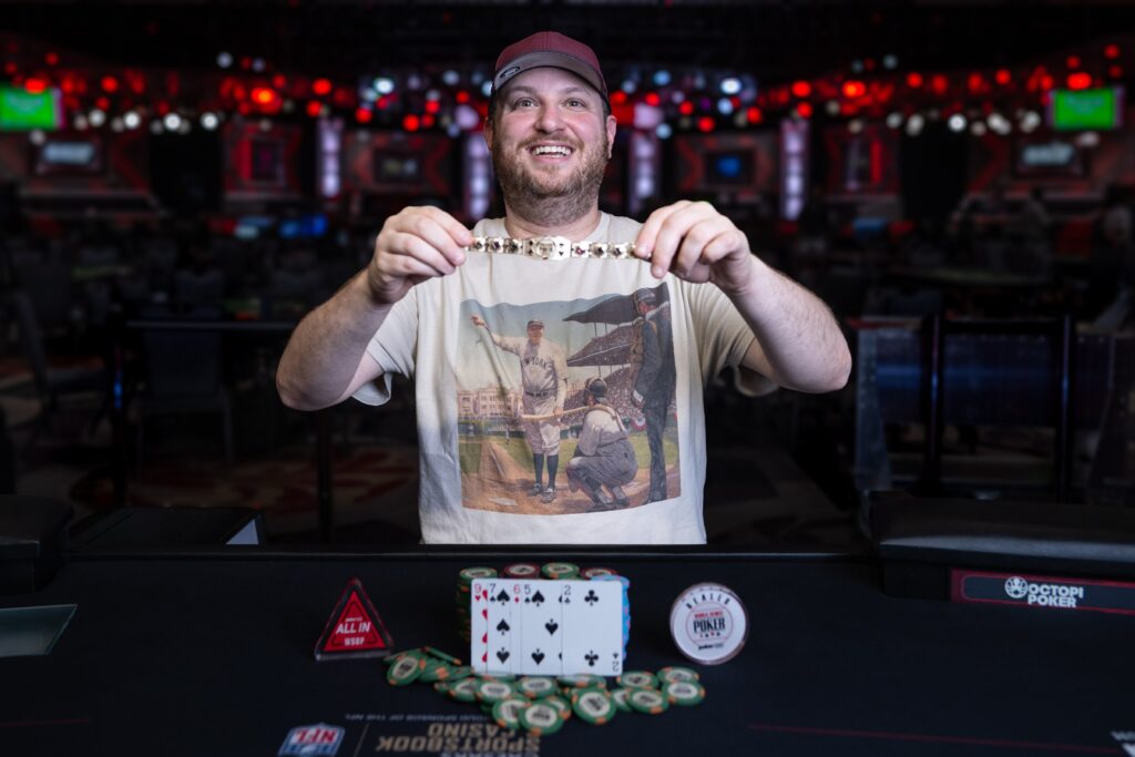 Scot Seiver holding the World Series of Poker (WSOP) trophy after his recent win.